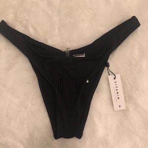 Vitamin A - Black. Never worn, tags still on.